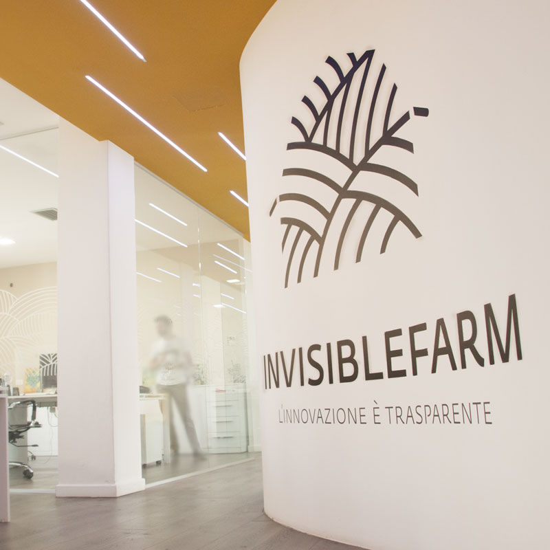 Ingresso dell'ufficio di Invisiblefarm con logo sulla parete